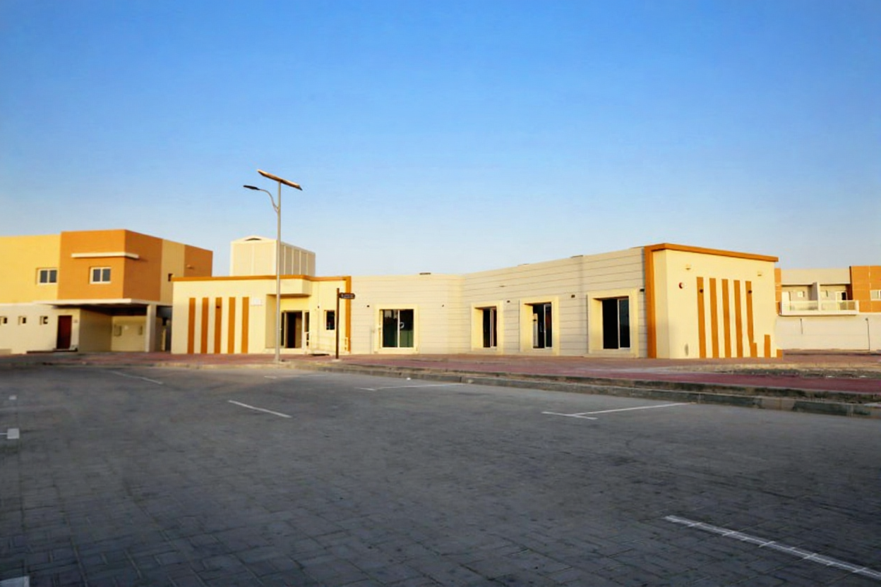 Exterior view of Manazel Al Reef 2 in Al Samha, Abu Dhabi, showcasing modern villas with landscaped streets and family-friendly design.