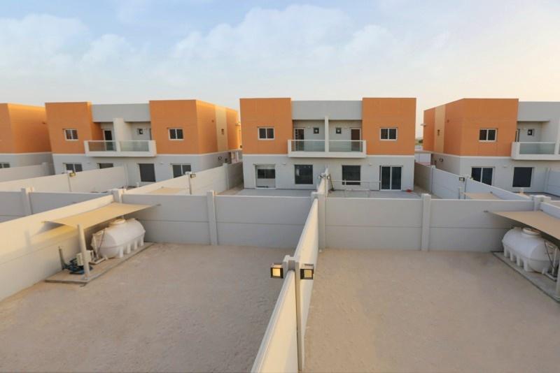 Contemporary living room interior at Manazel Al Reef 2 Al Samha Abu Dhabi, highlighting spacious layout and natural light-filled ambiance.